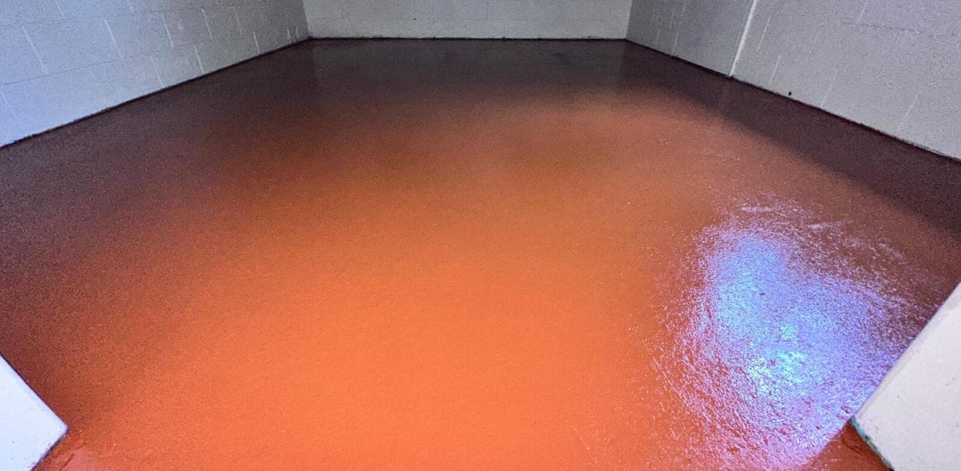 Epoxy-coated concrete floor in an interior utility room